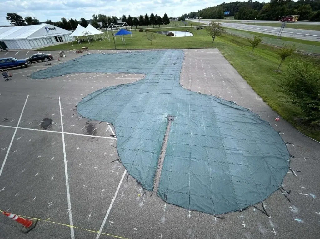 Gray custom pool safety cover stretched across pool.